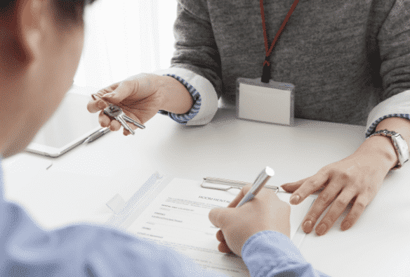Property solicitor talking to a client while signing agreement